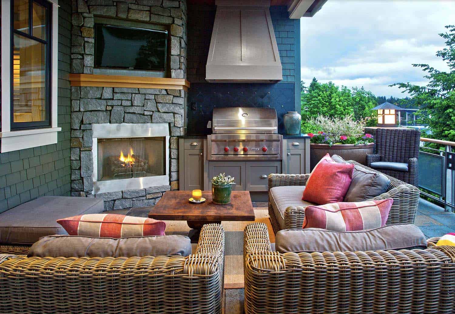 outdoor deck with a fireplace and grilling station