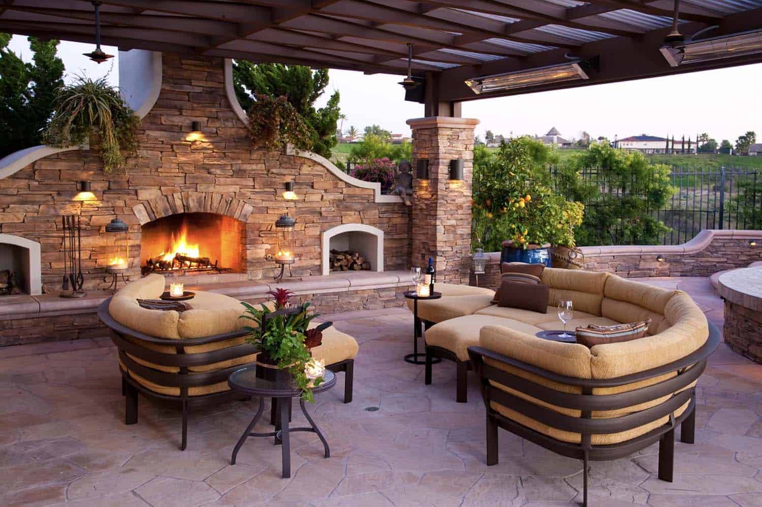 mediterranean style patio with a fireplace and outdoor furniture