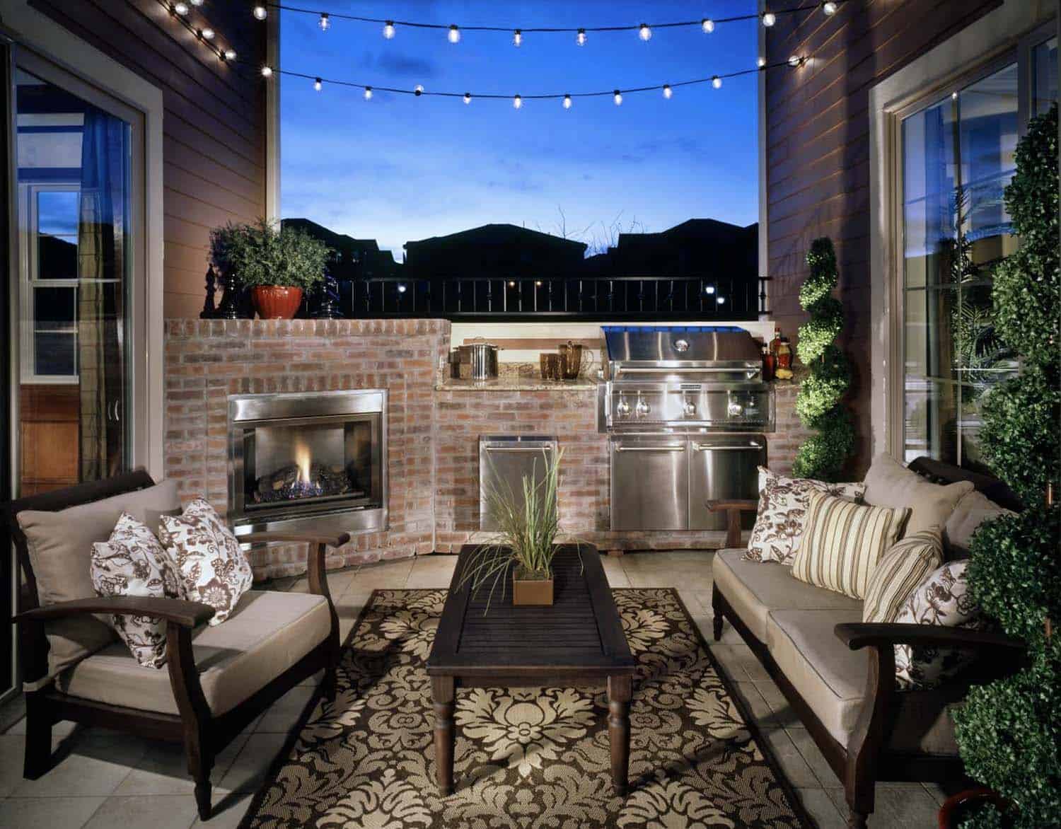 urban patio with a fireplace, grill, and outdoor furniture