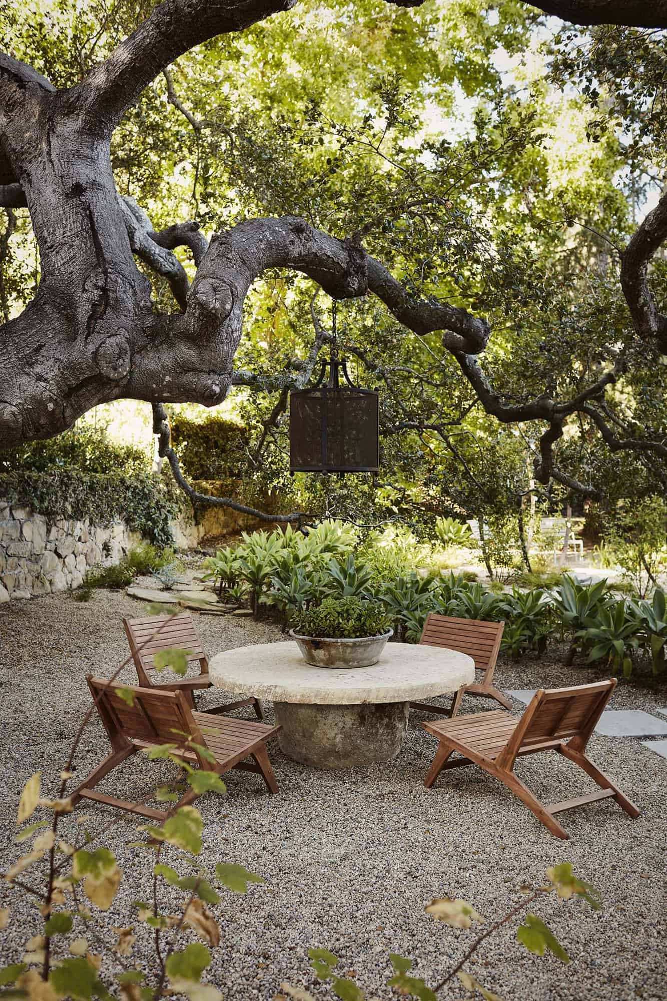 outdoor living room under an oak tree with vintage lights
