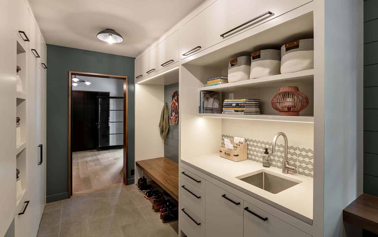 modern mudroom with a sink and built-in bench