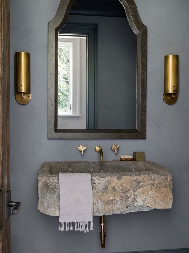 contemporary powder room with a custom stone sink