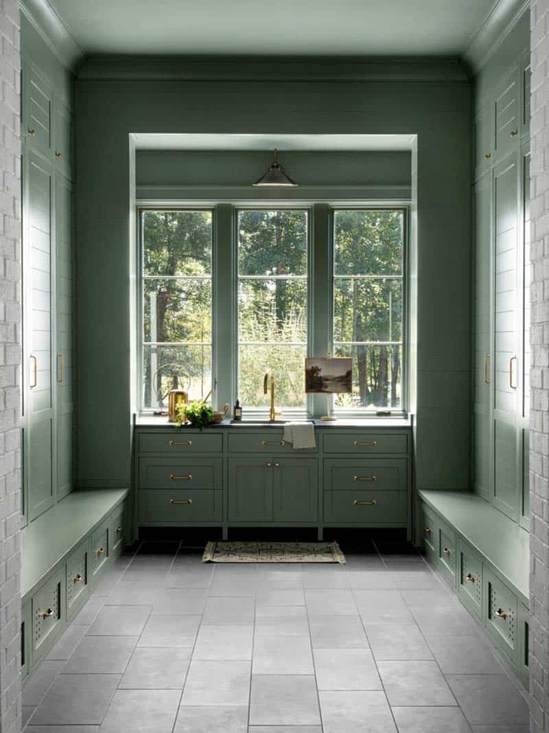 contemporary mudroom with built-in cabinets painted green