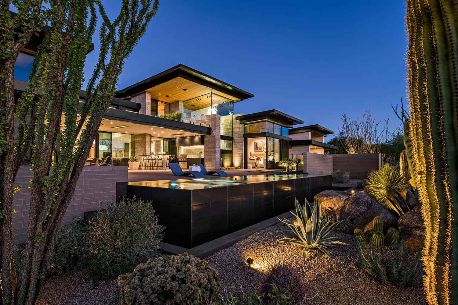 contemporary desert home swimming pool at dusk