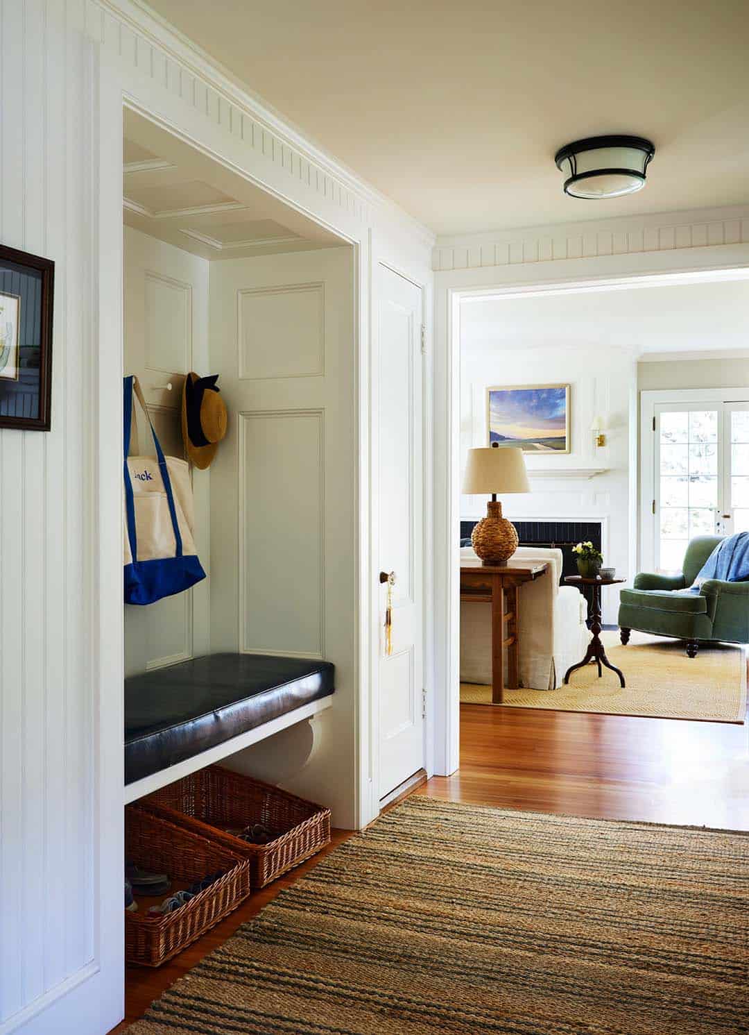 beach style entry with a built-in leather bench and closets