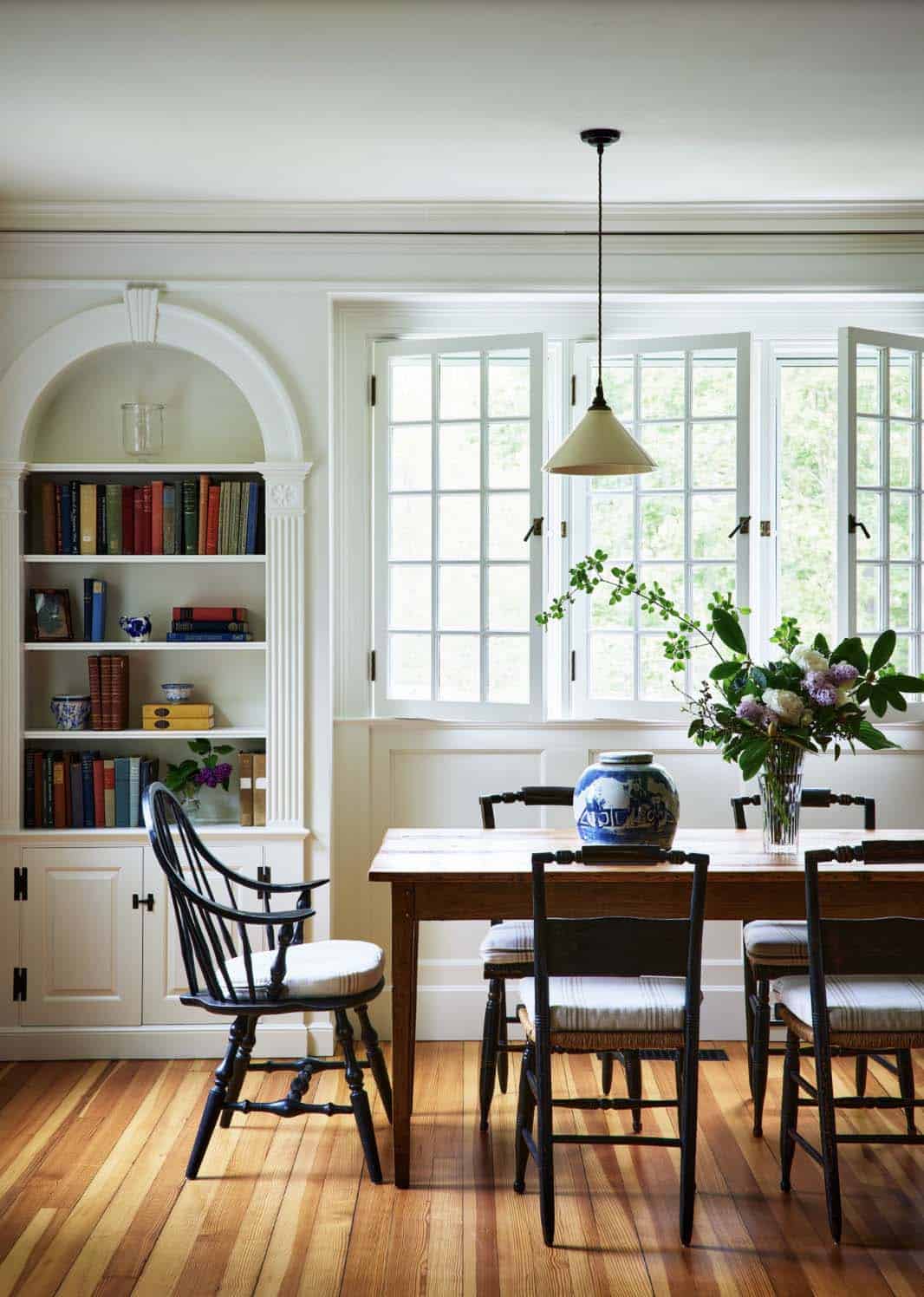 beach style dining room with built-in bookcase