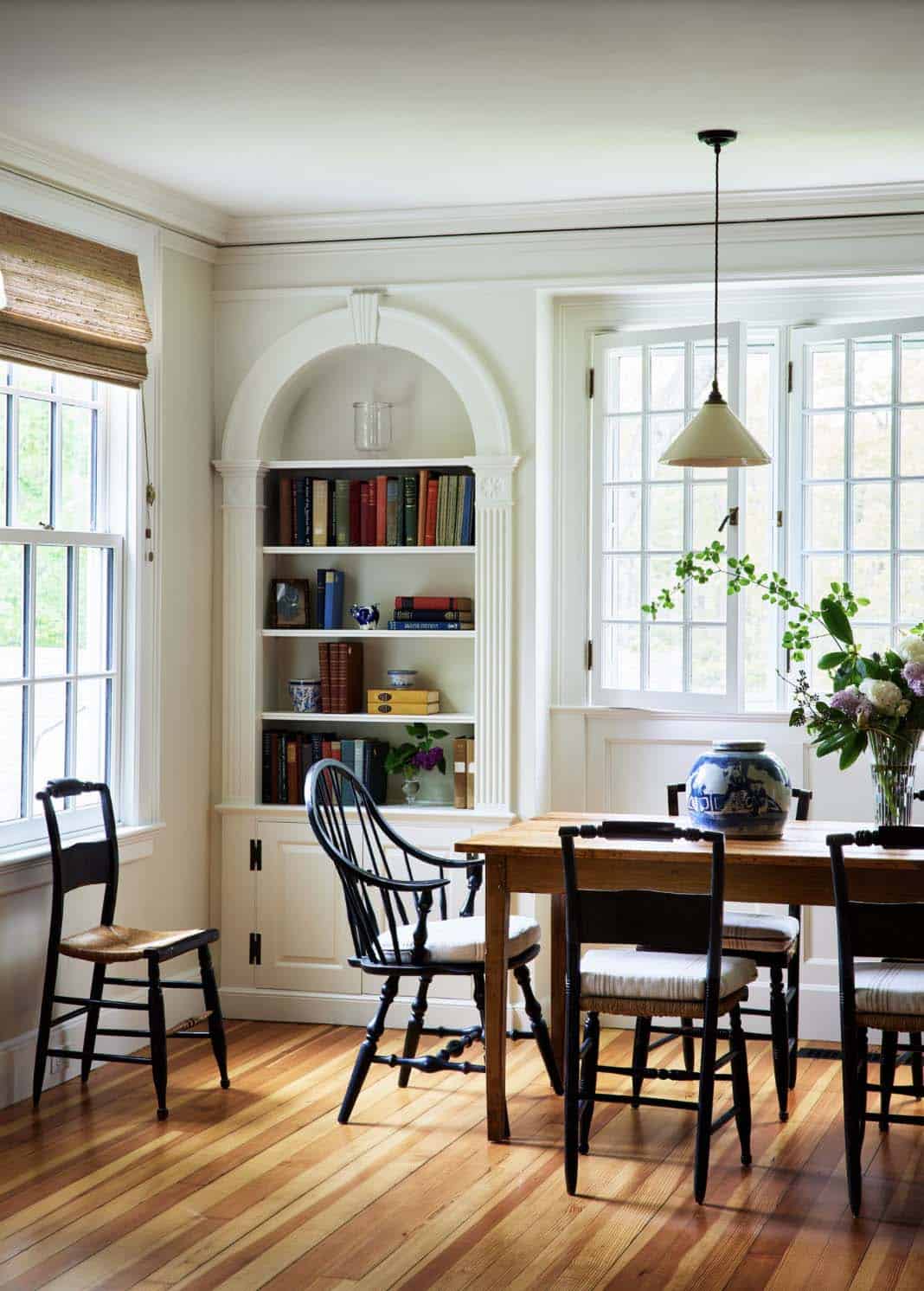 beach style dining room with built-in bookcase