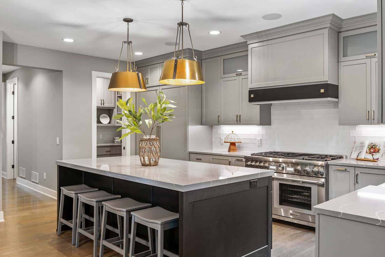 modern farmhouse kitchen with large gold pendant lights