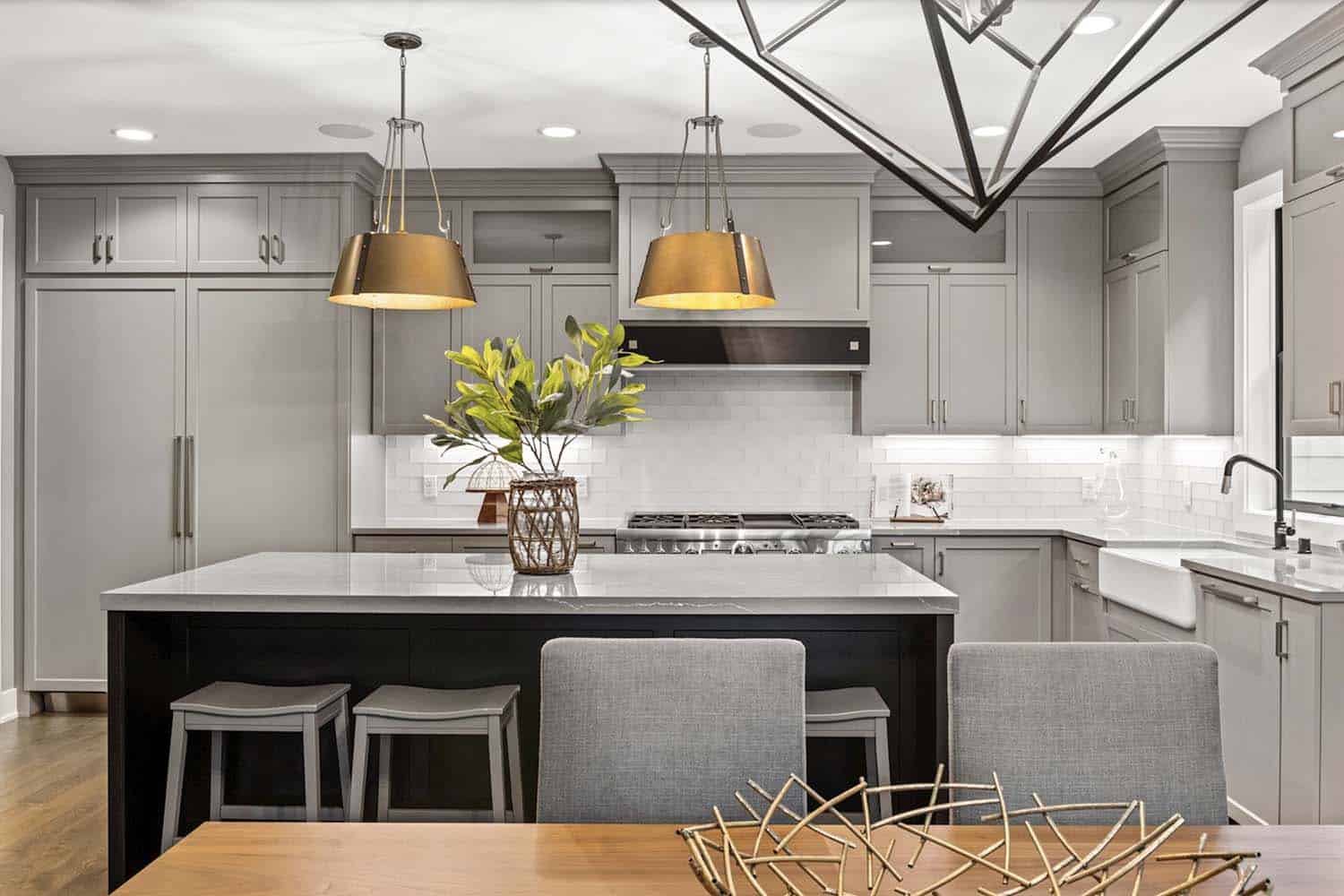 modern farmhouse kitchen with large gold pendant lights