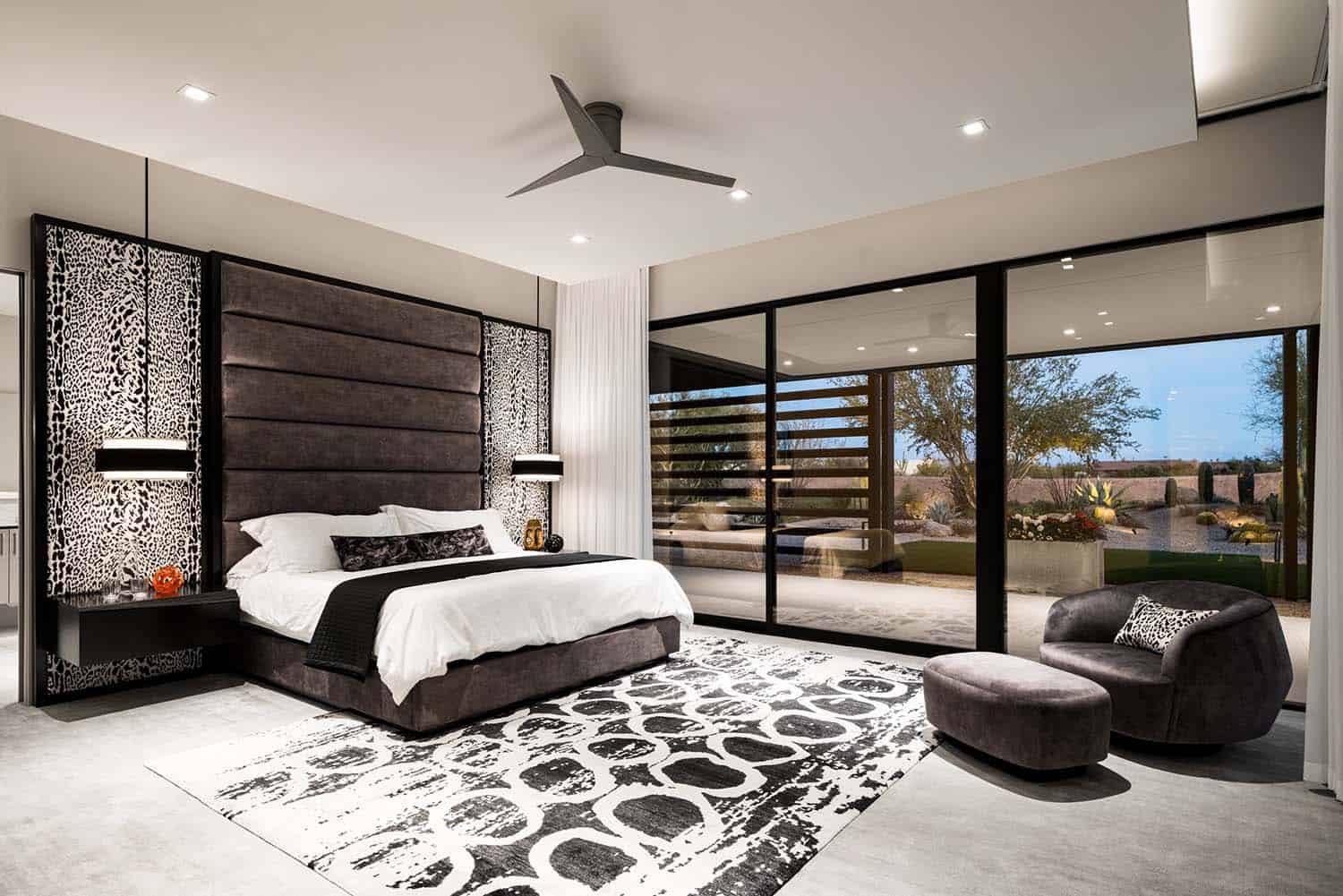 modern bedroom with sliding glass doors leading out to the backyard patio