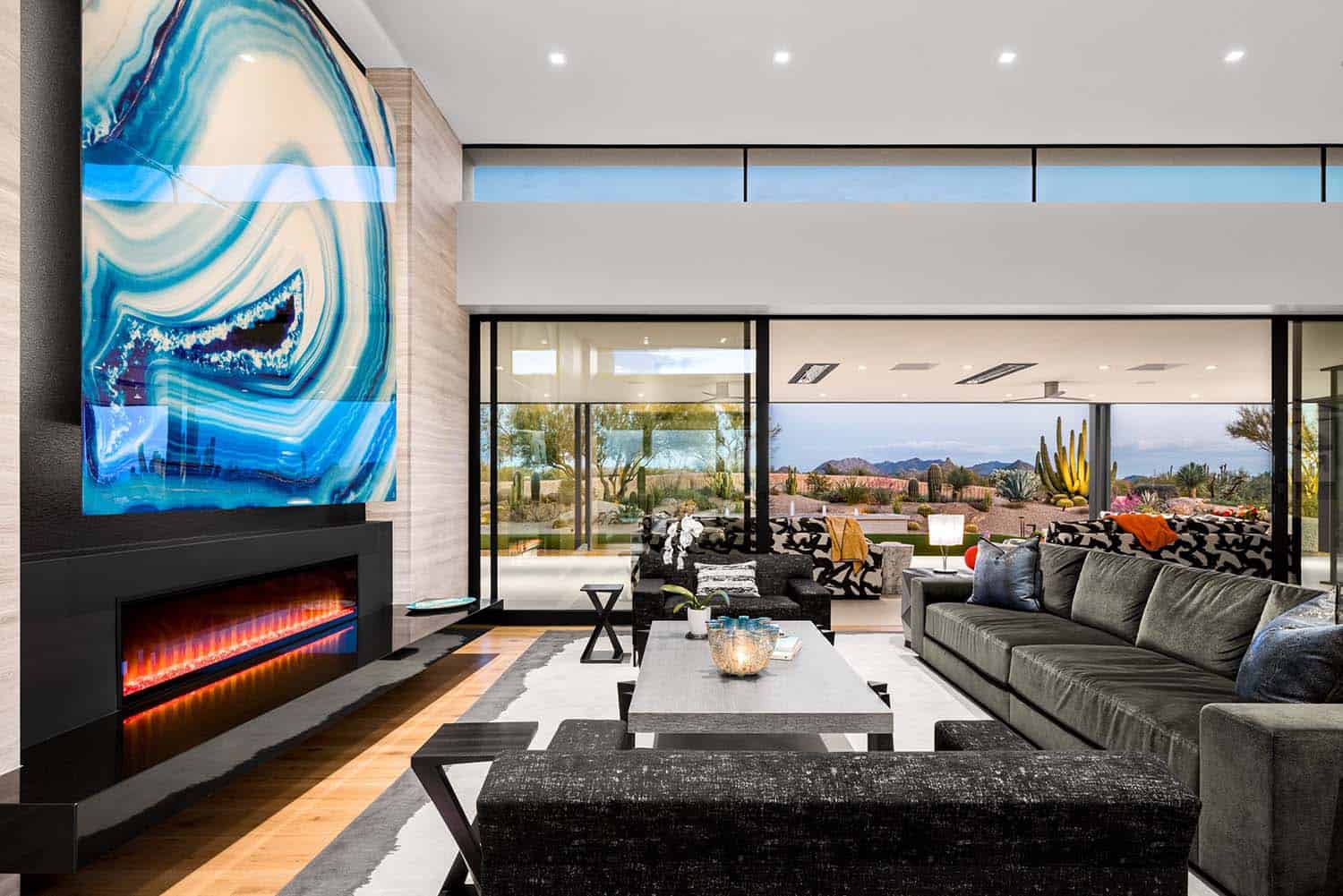 modern living room with a fireplace and sliding glass doors leading out to the backyard patio