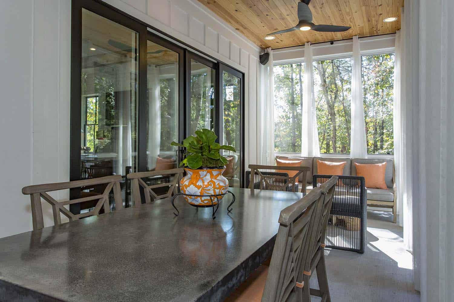 modern farmhouse covered porch with outdoor dining and lounge furniture