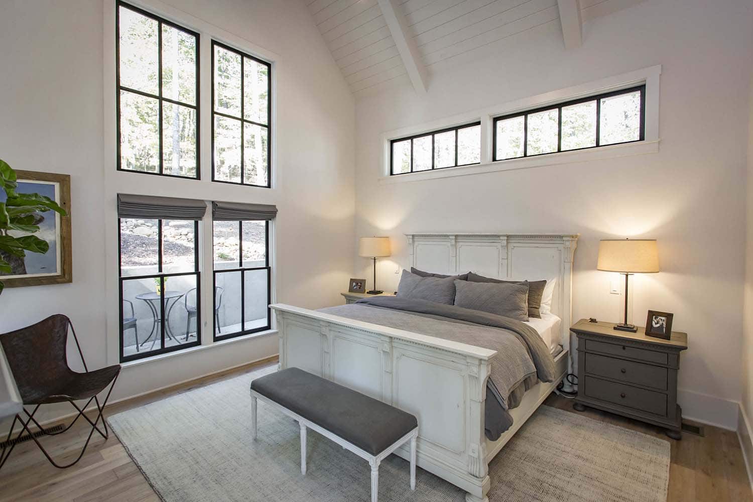 modern farmhouse bedroom with a vaulted ceiling