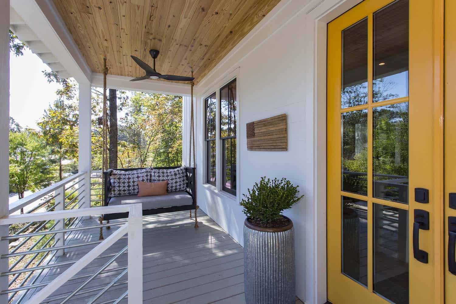 modern farmhouse home front porch with a yellow entry door