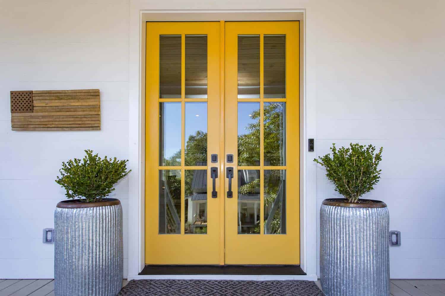 modern farmhouse home with a yellow entry door