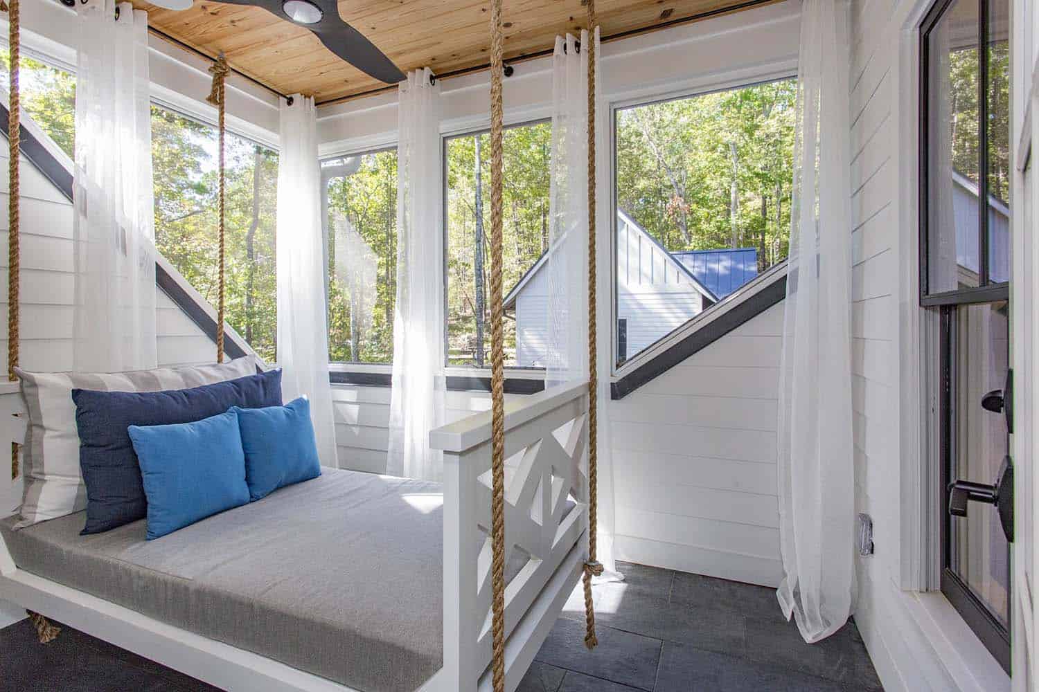 modern farmhouse balcony with a hanging swing