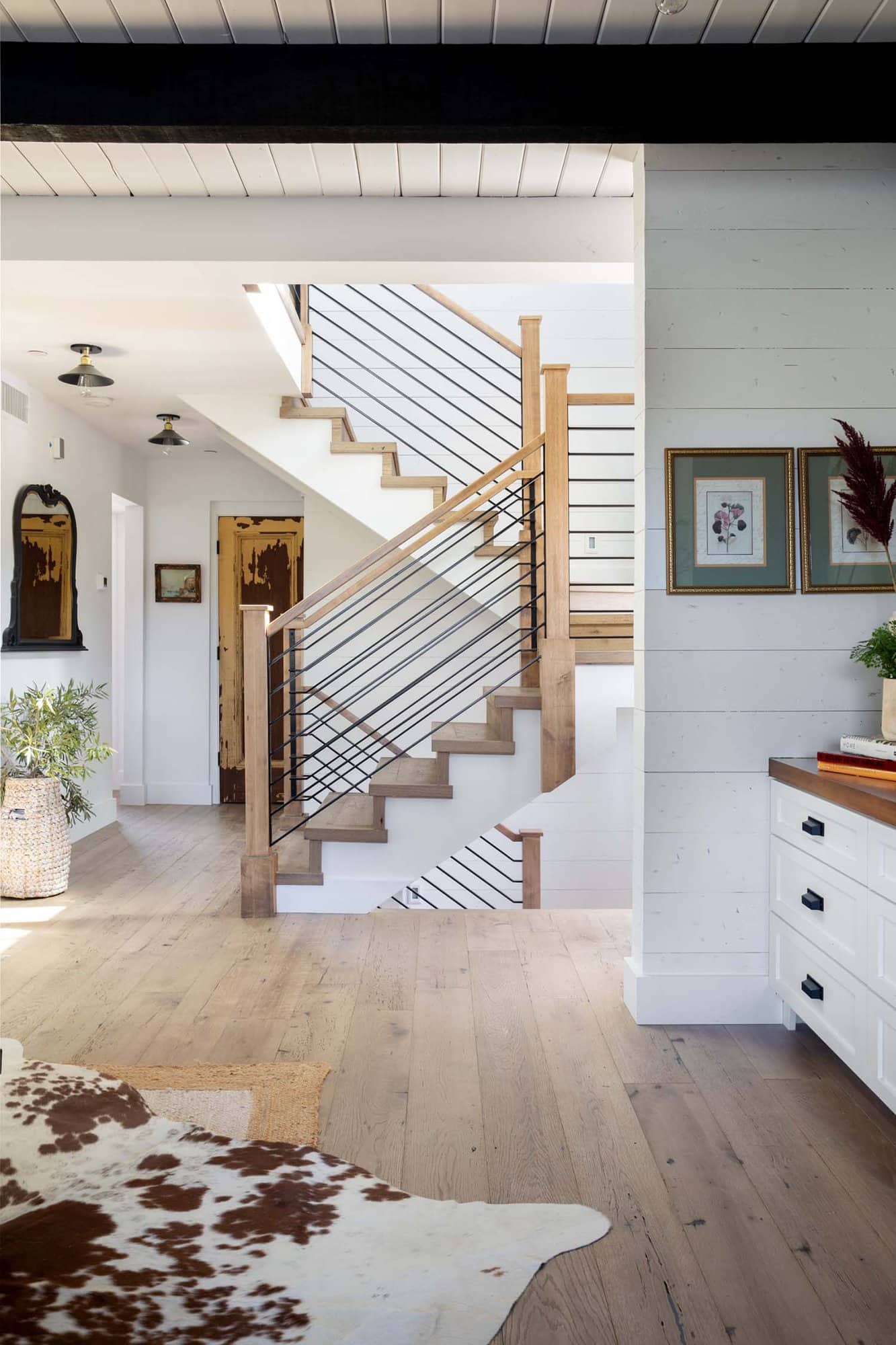 modern farmhouse living room with a view to the stairs