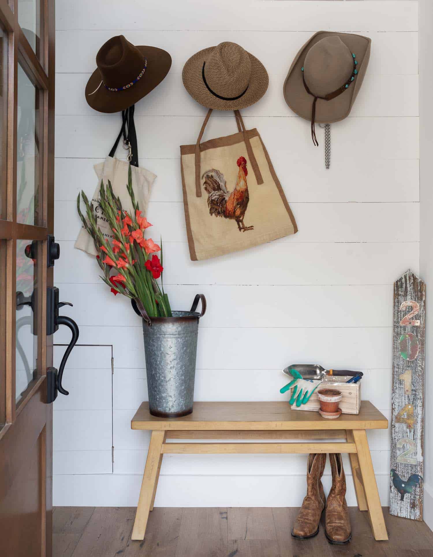 modern farmhouse mudroom entry with a bench