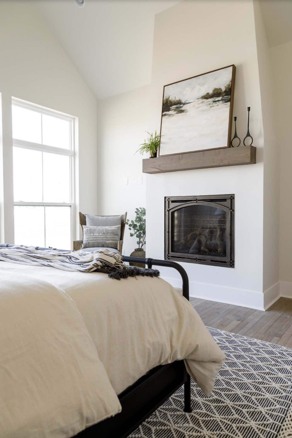 farmhouse style bedroom with a fireplace