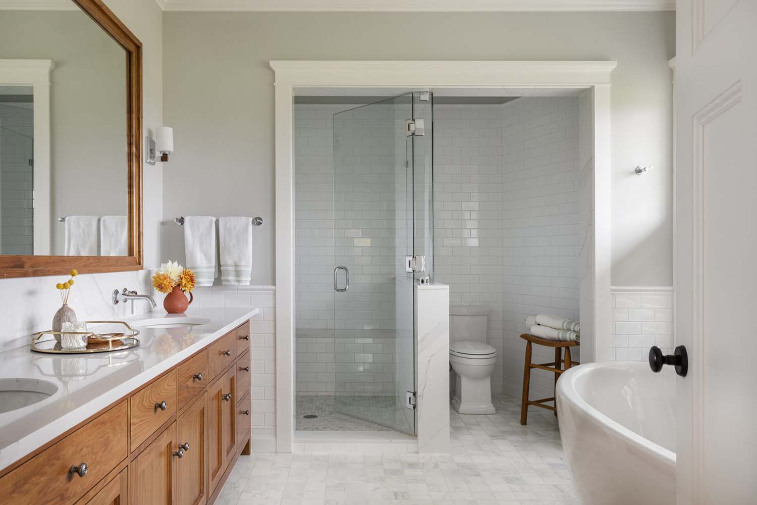 modern farmhouse bathroom with a vanity, freestanding tub and glass enclosed shower