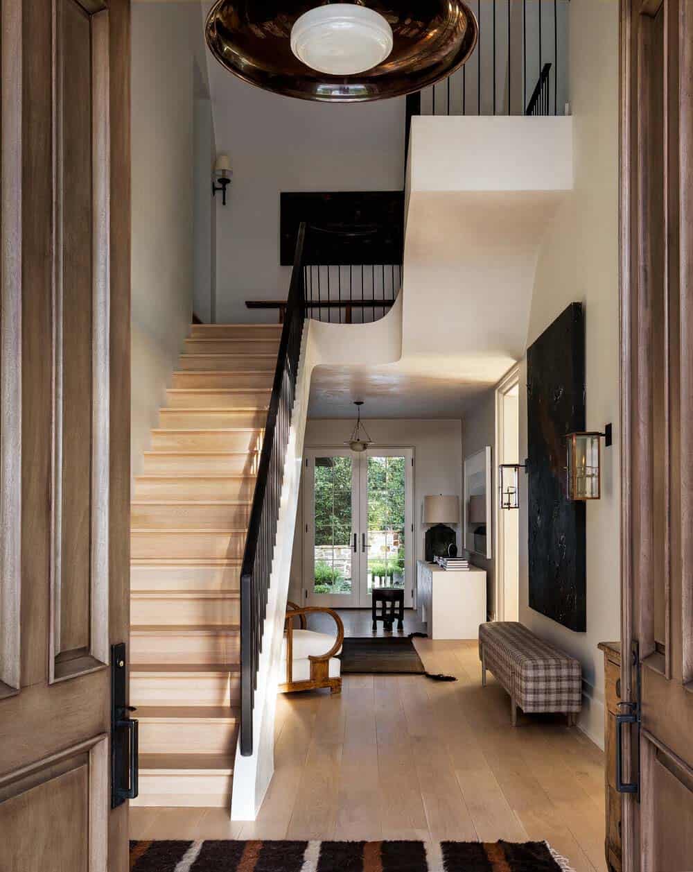 modern rustic villa entry with a view of the staircase