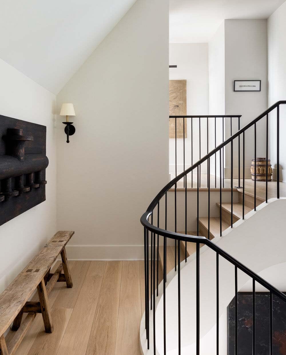 modern rustic staircase landing with a wooden bench
