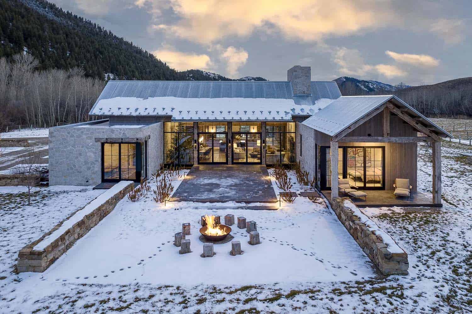 mountain home backyard with a fire pit and surrounded by snow