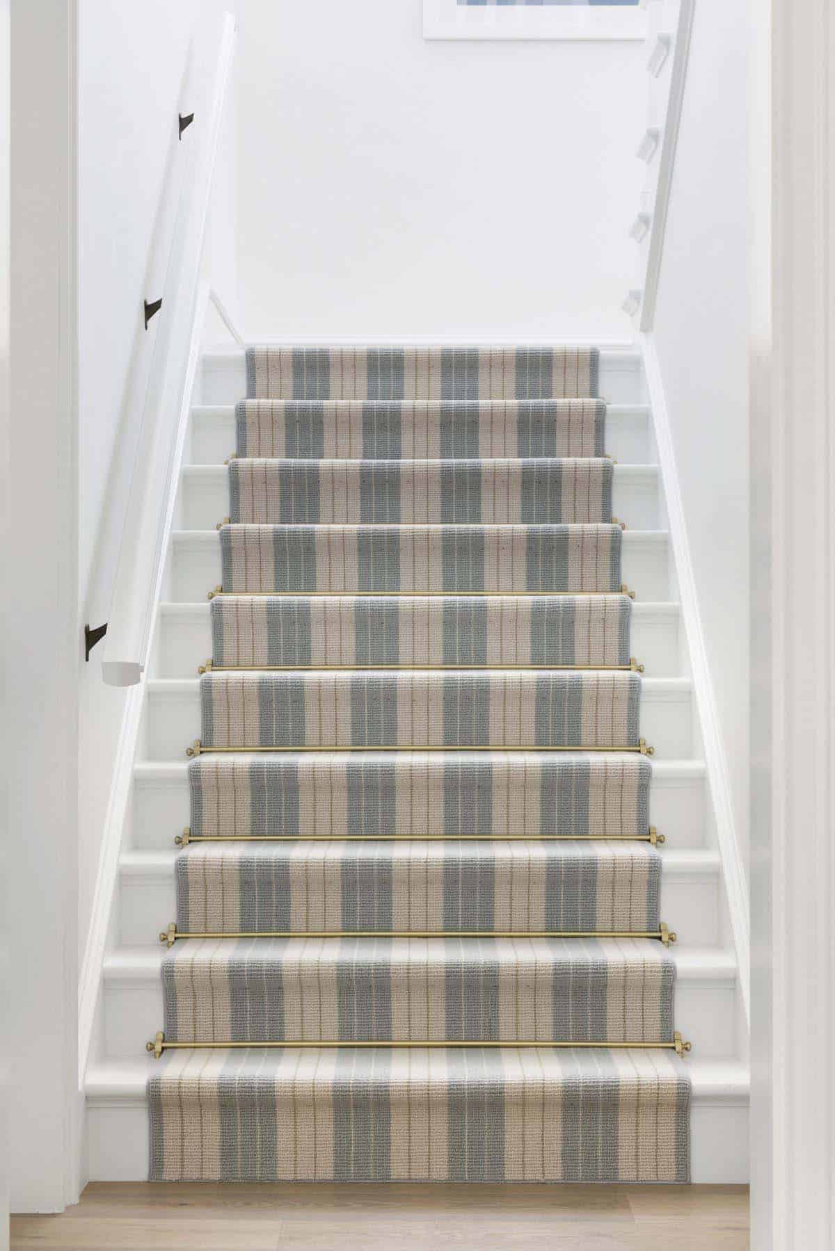 coastal style staircase with a carpet runner