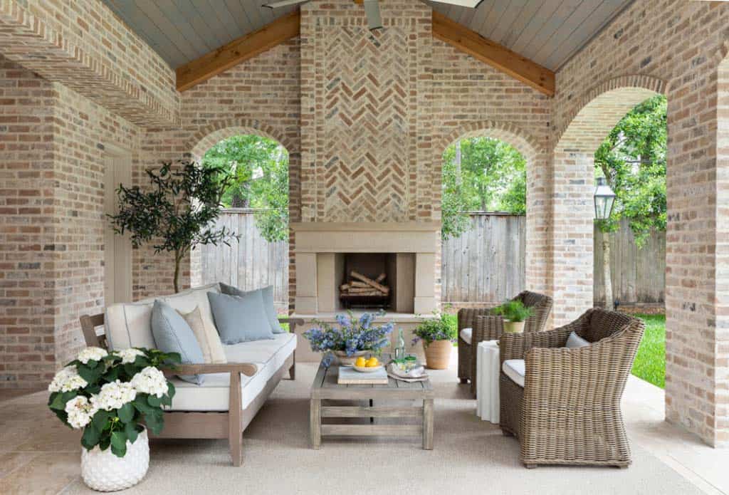 traditional covered patio with a fireplace