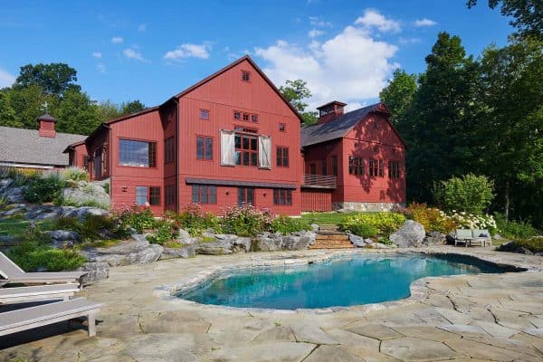 red barn exterior with a swimming pool