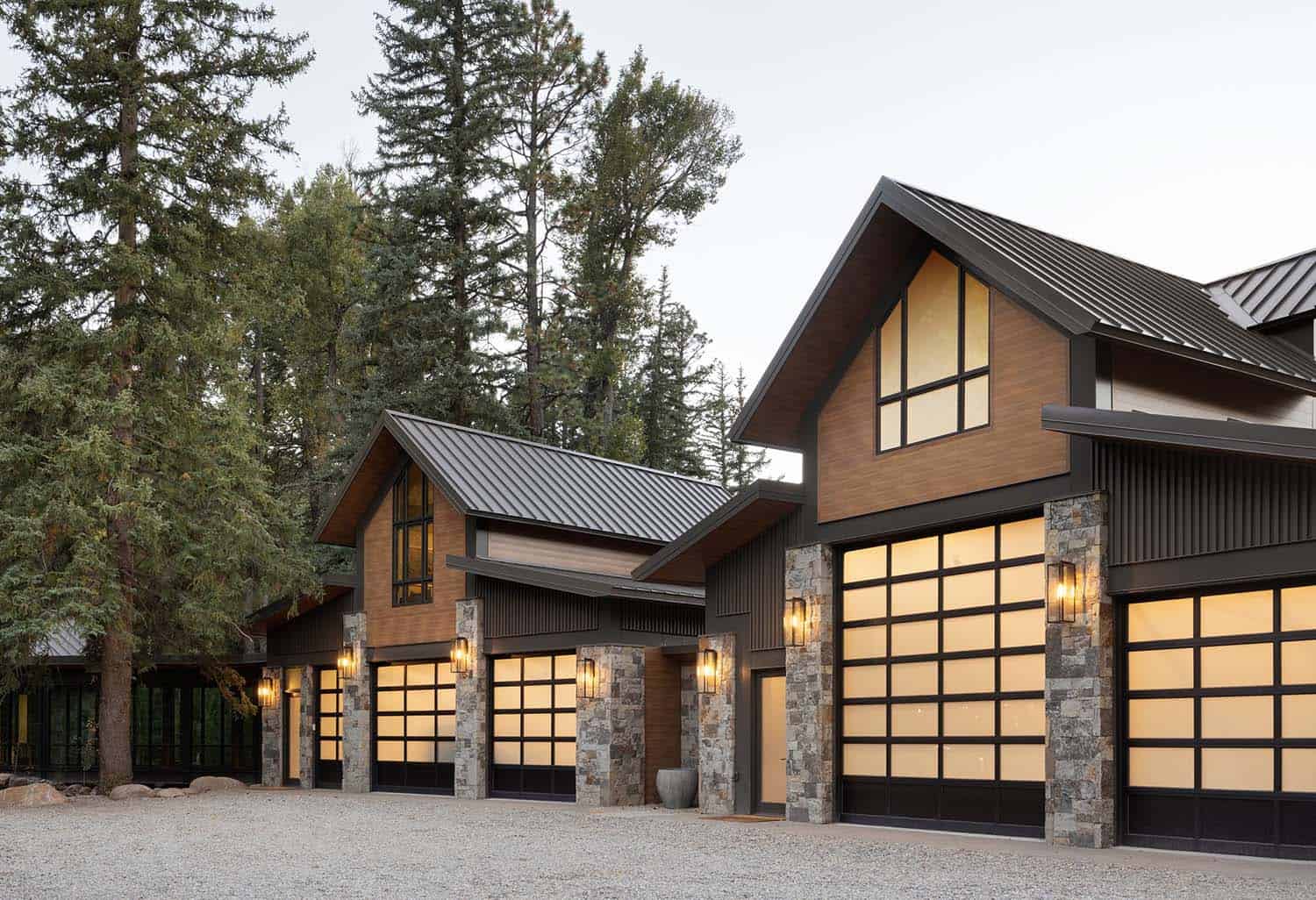 modern rustic mountain home garage exterior at dusk
