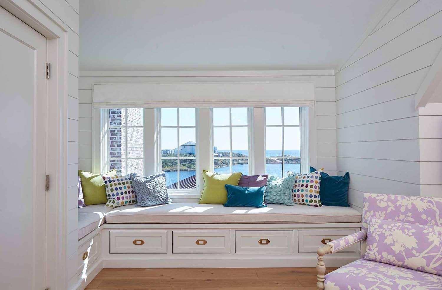 beach style kids bedroom with a window seat