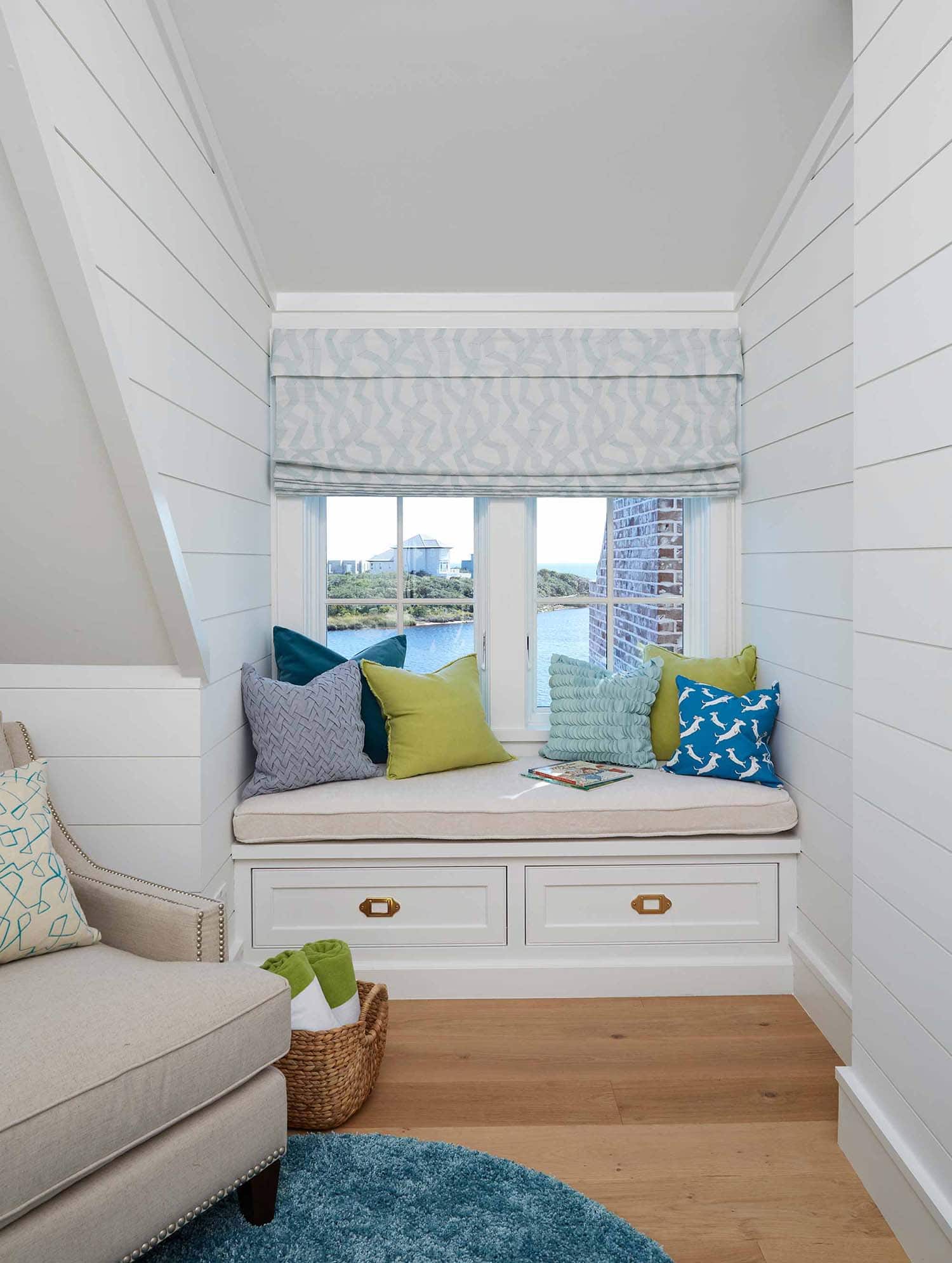 beach style kids bedroom with a window seat